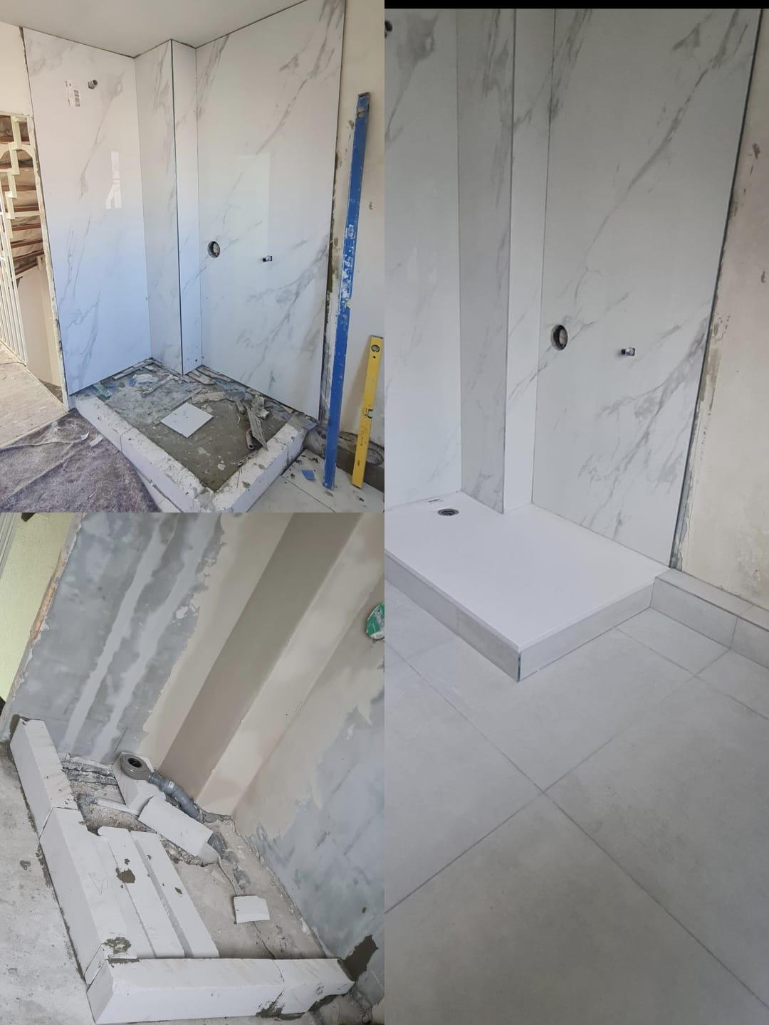 Badezimmerausbau mit großformatigen Fliesen in Marmoroptik.